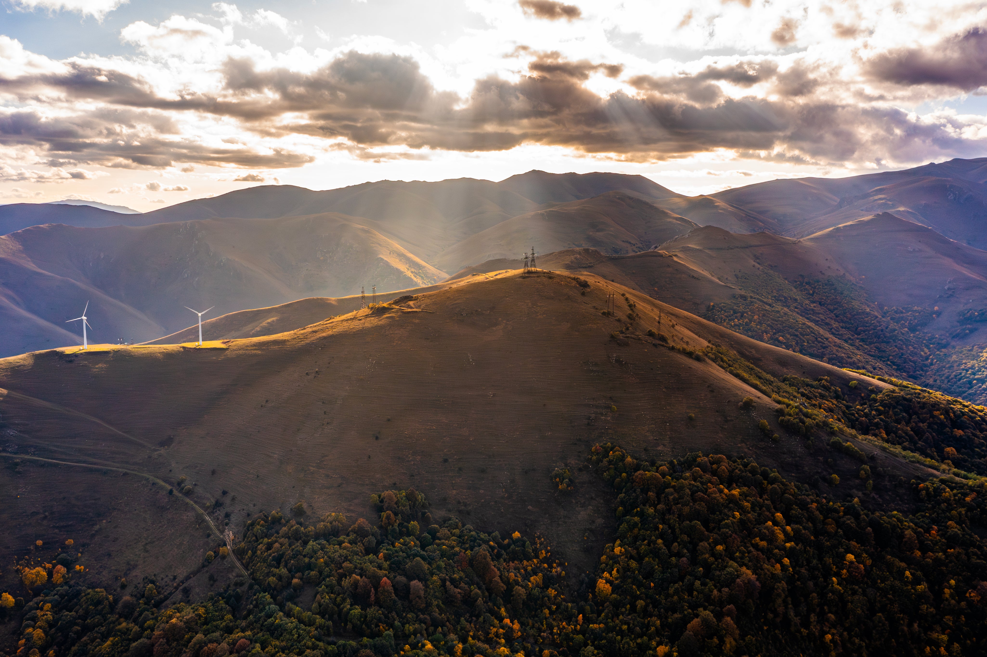 aerial-shot-of-a-landscape-and-a-wind-turbine-on-a-2024-06-07-01-36-03-utc.jpg